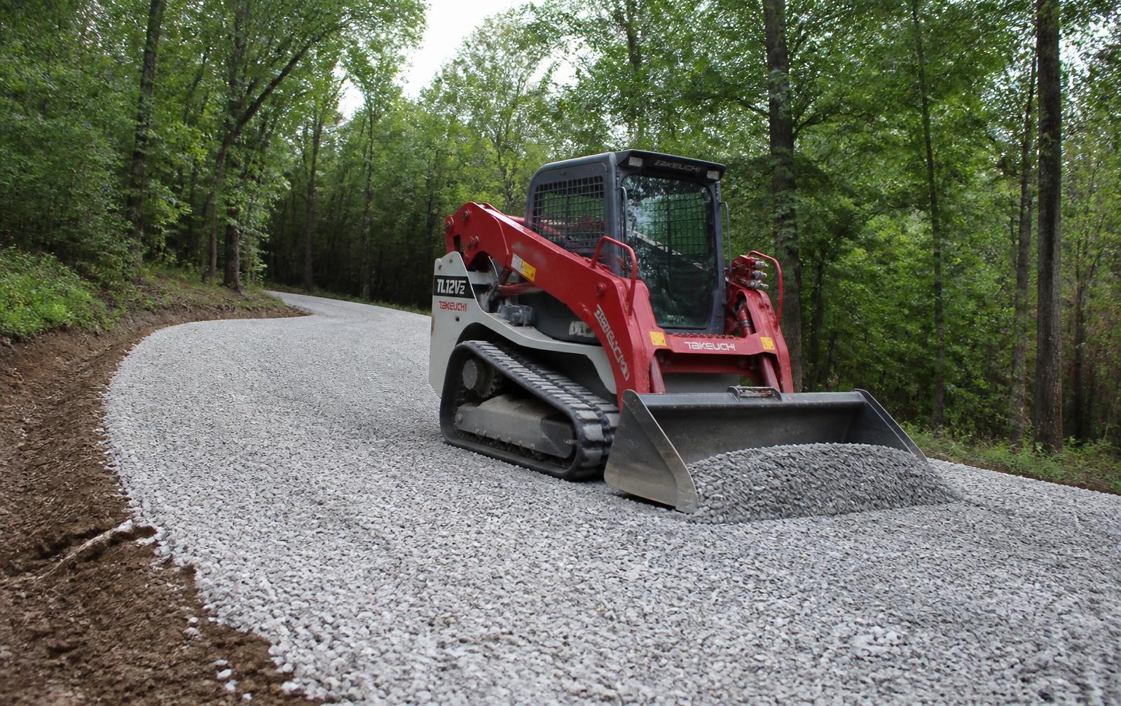 Takeuchi TL12V2 grading a new gravel driveway through Missouri woods